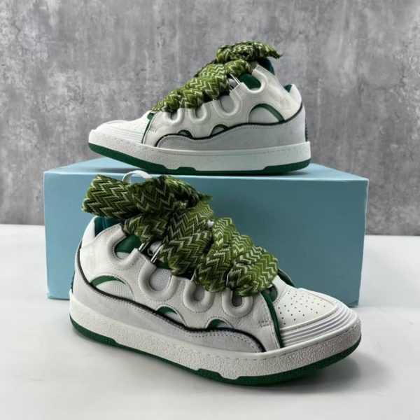 The Curb is a ’90s-inspired sneaker with an assertive design and exaggerated volumes. Made from nappa calfskin, suede and mesh, this elaborately assembled model features ultimate comfort thanks to its round shape, padded tongue and metallic eyelets. Curb leather sneakers Almond toe Waxed and woven double laces with a herringbone motif Quilted tongue with the Lanvin label and an embossed Mother and Child logo