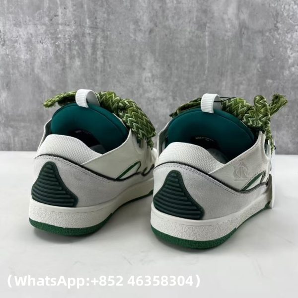 The Curb is a ’90s-inspired sneaker with an assertive design and exaggerated volumes. Made from nappa calfskin, suede and mesh, this elaborately assembled model features ultimate comfort thanks to its round shape, padded tongue and metallic eyelets. Curb leather sneakers Almond toe Waxed and woven double laces with a herringbone motif Quilted tongue with the Lanvin label and an embossed Mother and Child logo