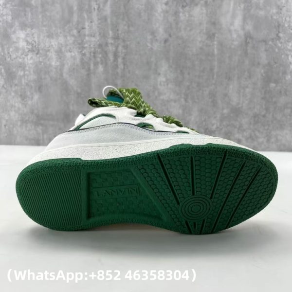 The Curb is a ’90s-inspired sneaker with an assertive design and exaggerated volumes. Made from nappa calfskin, suede and mesh, this elaborately assembled model features ultimate comfort thanks to its round shape, padded tongue and metallic eyelets. Curb leather sneakers Almond toe Waxed and woven double laces with a herringbone motif Quilted tongue with the Lanvin label and an embossed Mother and Child logo
