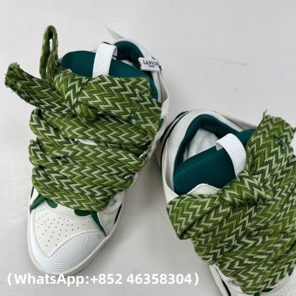 The Curb is a ’90s-inspired sneaker with an assertive design and exaggerated volumes. Made from nappa calfskin, suede and mesh, this elaborately assembled model features ultimate comfort thanks to its round shape, padded tongue and metallic eyelets. Curb leather sneakers Almond toe Waxed and woven double laces with a herringbone motif Quilted tongue with the Lanvin label and an embossed Mother and Child logo