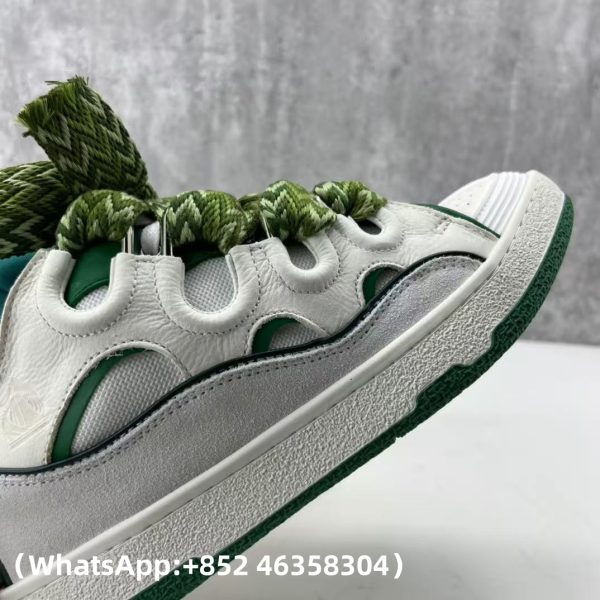 The Curb is a ’90s-inspired sneaker with an assertive design and exaggerated volumes. Made from nappa calfskin, suede and mesh, this elaborately assembled model features ultimate comfort thanks to its round shape, padded tongue and metallic eyelets. Curb leather sneakers Almond toe Waxed and woven double laces with a herringbone motif Quilted tongue with the Lanvin label and an embossed Mother and Child logo